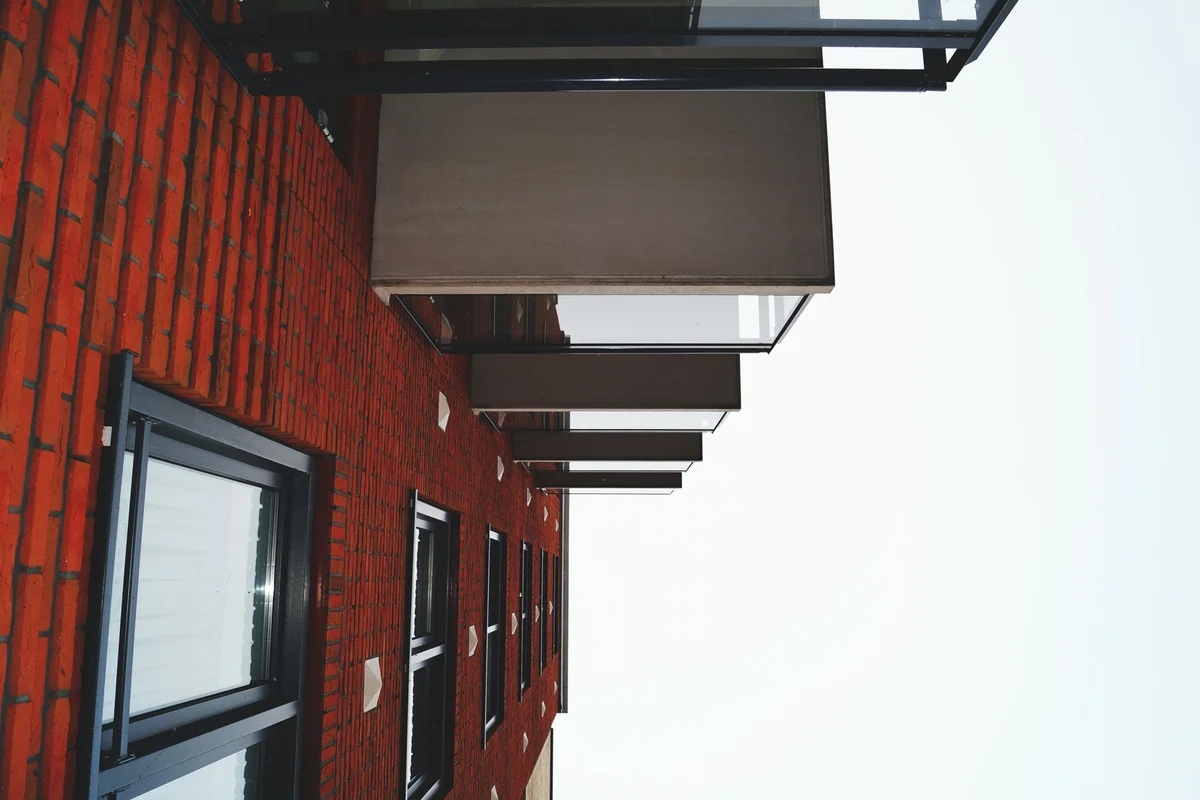 After: Front facade — deteriorated brick replaced with color-matched full-bed clay brick
