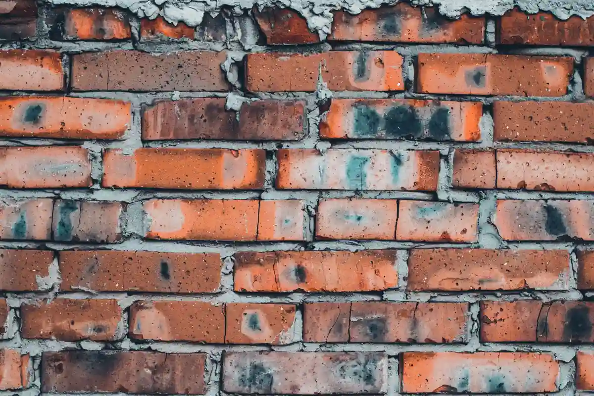Before: Entry wall — mortar-matched joints with consistent tooling profile throughout