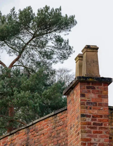 After: Side elevation — complete brick installation with proper wall tie placement