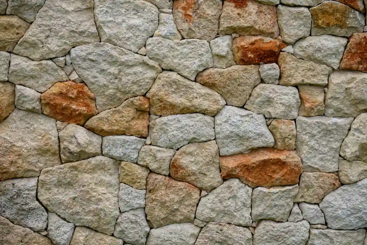 After: Front facade — dated siding removed, stone veneer installed over proper drainage mat