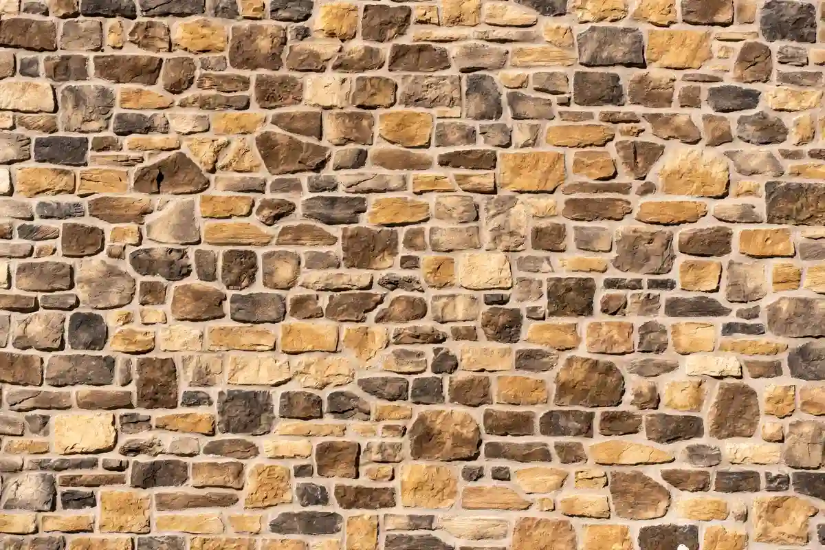 After: Front facade — dated siding removed, stone veneer installed over proper drainage mat