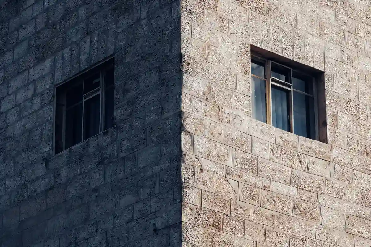 After: Side elevation — stone veneer cladding with soldier course cap detail at window sills