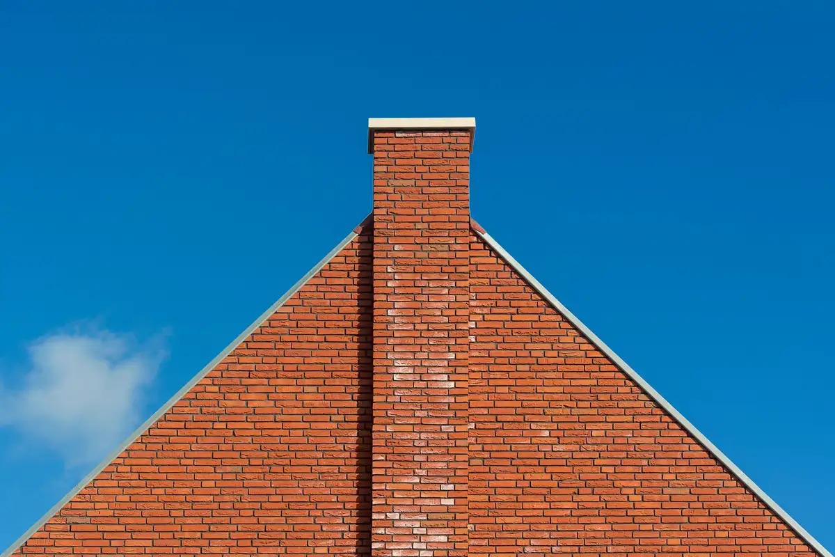 After: Full stack — original leaning chimney demolished to roofline and rebuilt in matching brick