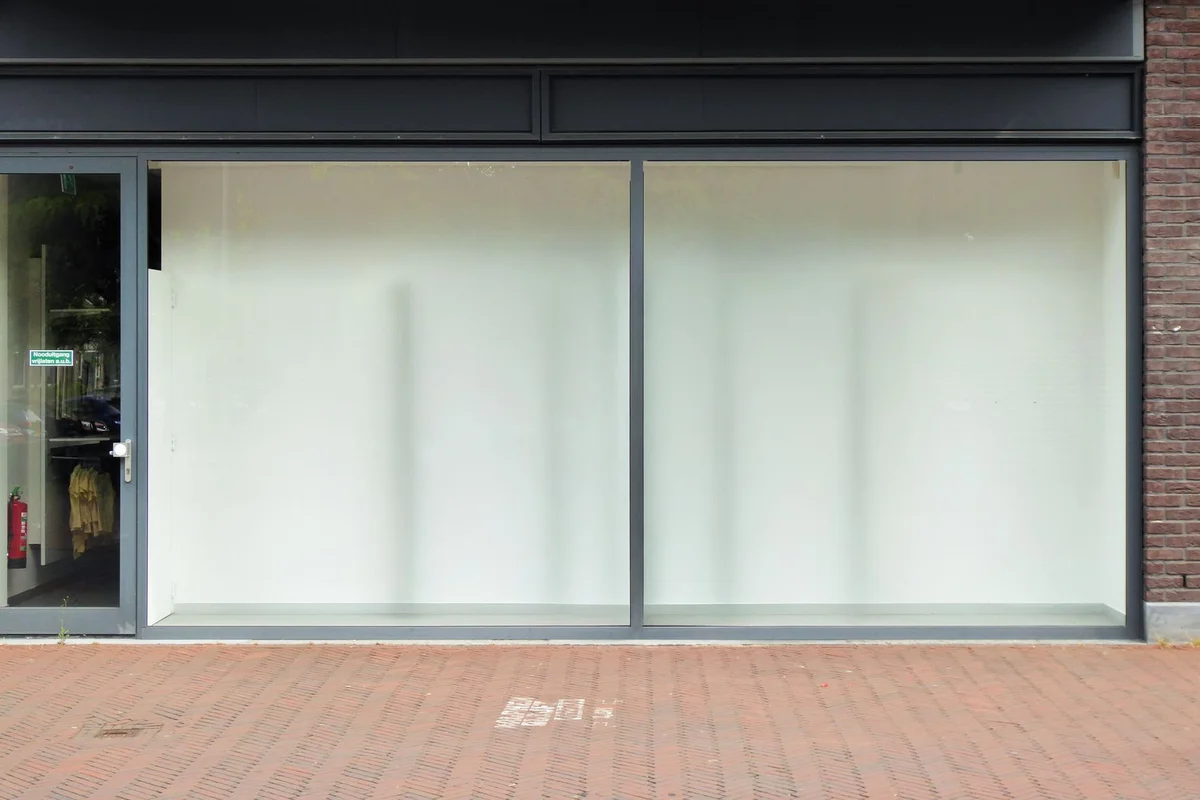 After: Storefront surround — original stone trim cleaned, repointed, and sealed