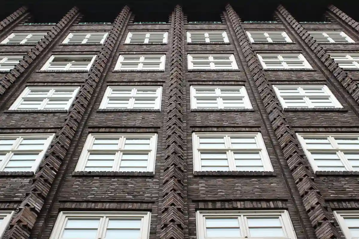 Before: Side elevation — stone veneer cladding with soldier course cap detail at window sills