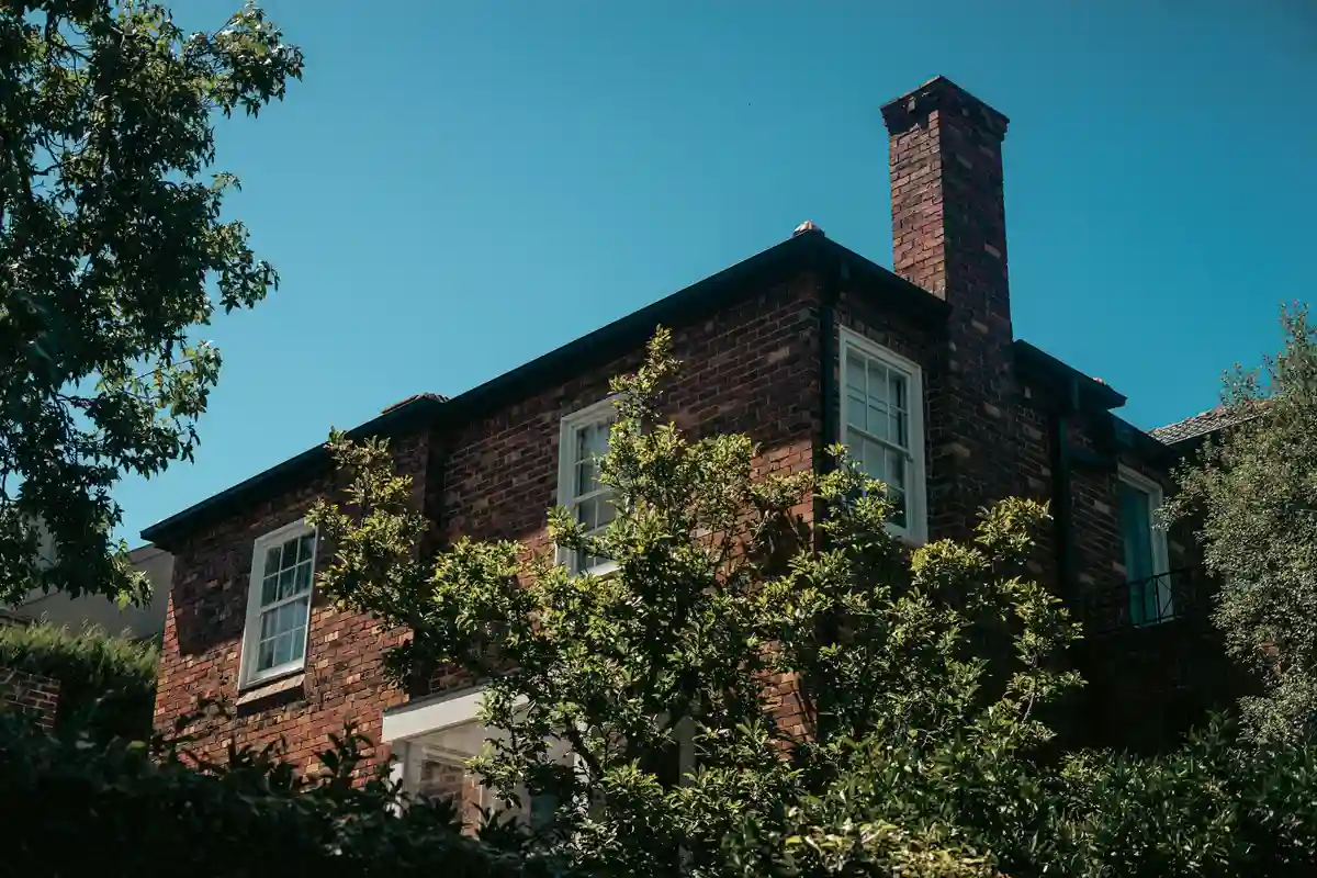 After: Stack exterior — spalling brick removed, matched replacements installed with fresh mortar