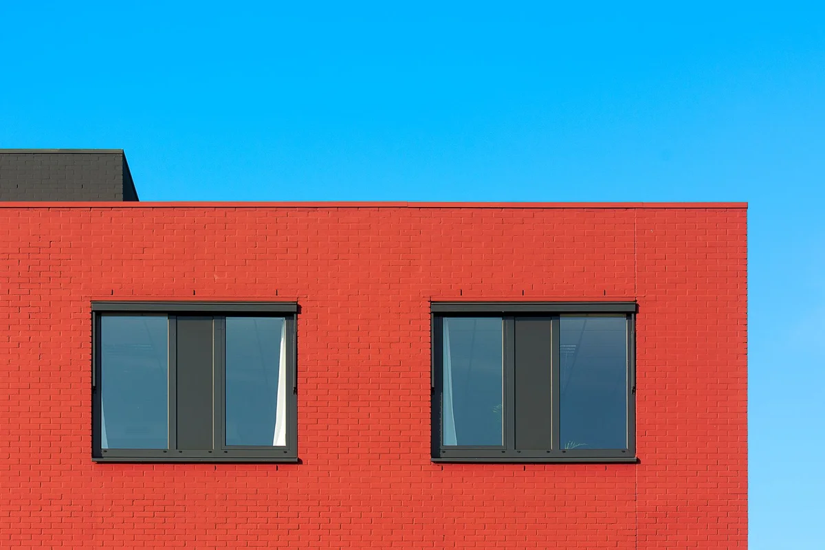 After: Front facade — deteriorated brick replaced with color-matched full-bed clay brick