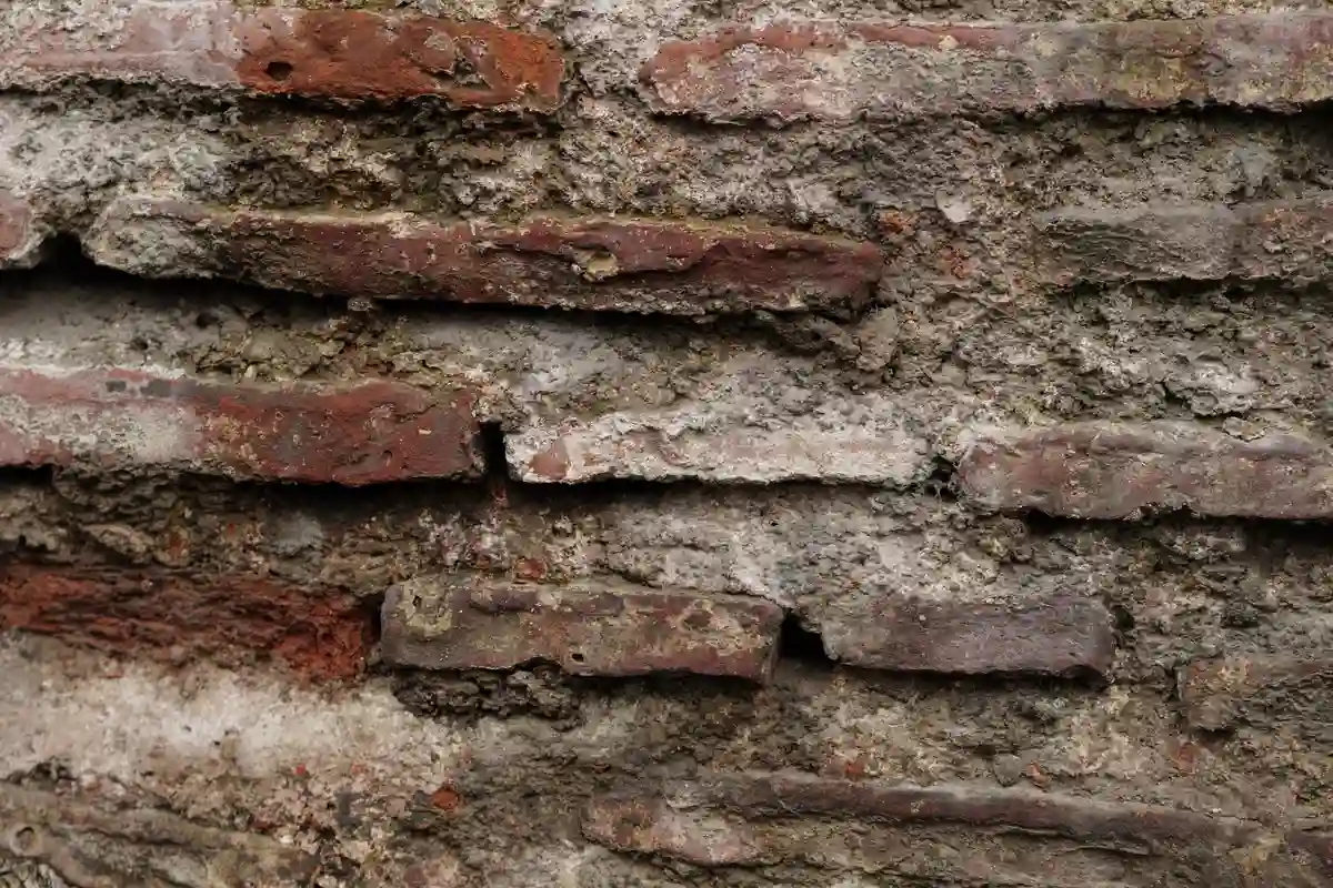 Before: Front facade — deteriorated brick replaced with color-matched full-bed clay brick