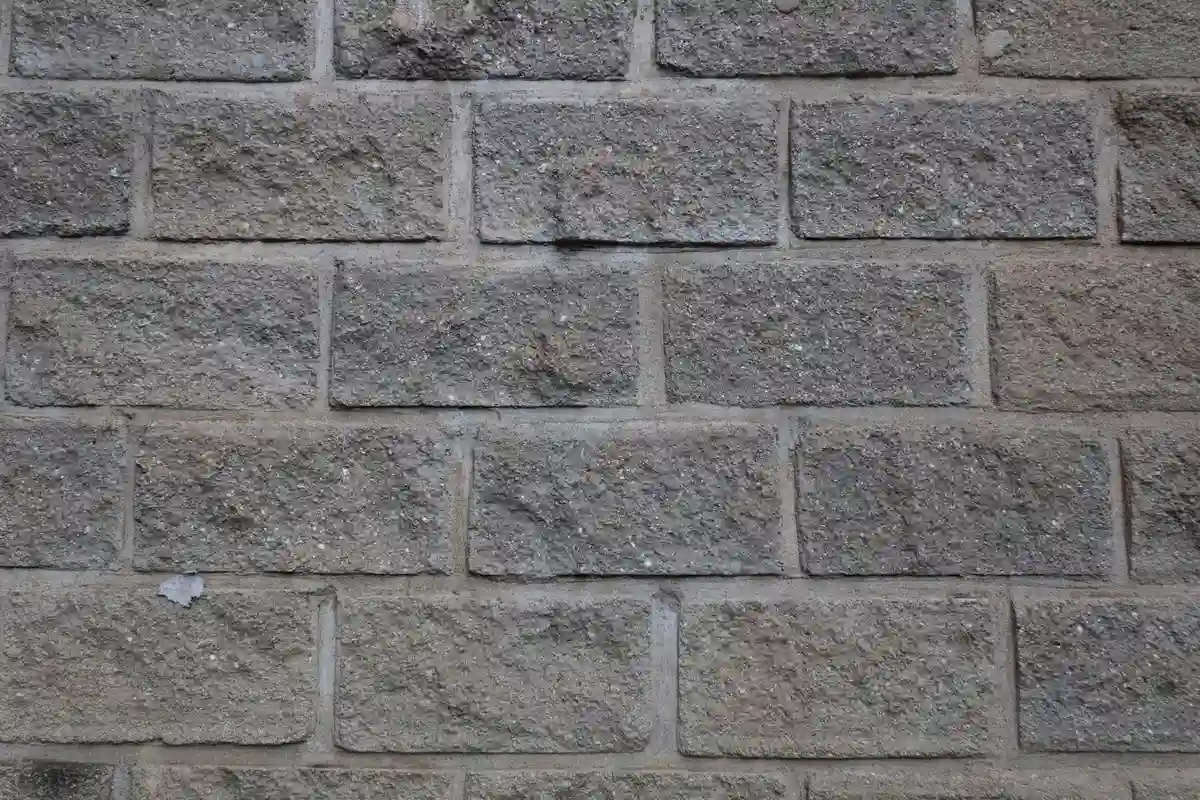 Before: Front wall — natural stone veneer installed over drainage mat with back-butter mortar