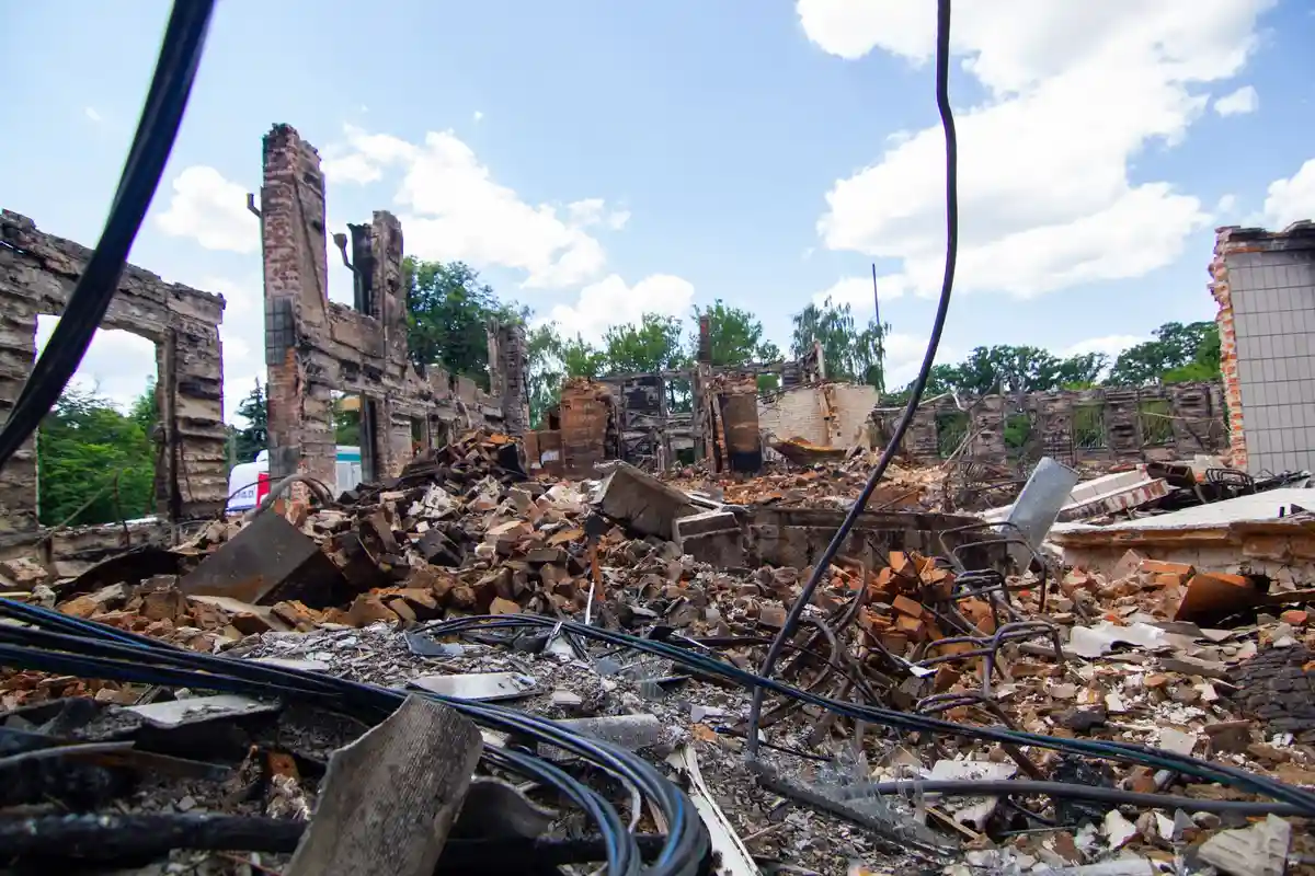 Before: Full stack — original leaning chimney demolished to roofline and rebuilt in matching brick