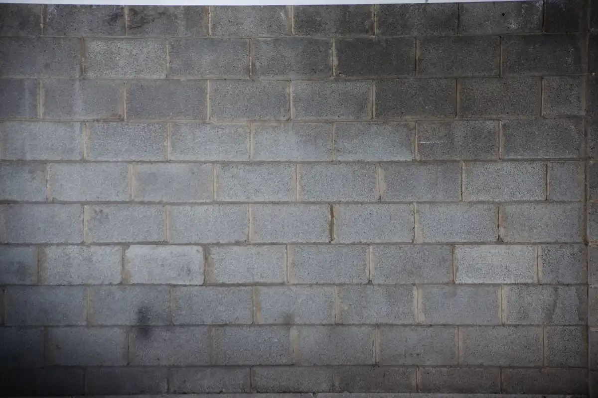 Before: Foundation section — CMU foundation wall built to code with full grouting and drainage