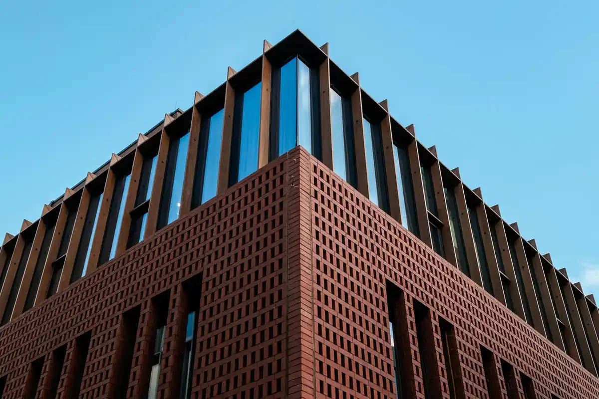 After: Main facade — original failing commercial brick restored and matched across full elevation