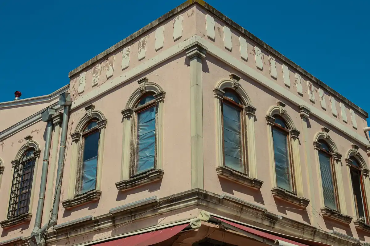 Before: Storefront surround — original stone trim cleaned, repointed, and sealed