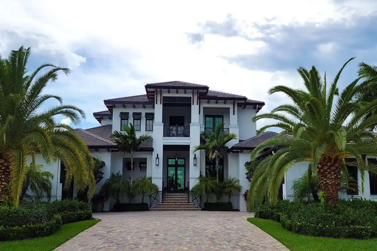 After: Primary facade — full exterior brick and limestone installation from foundation to roofline