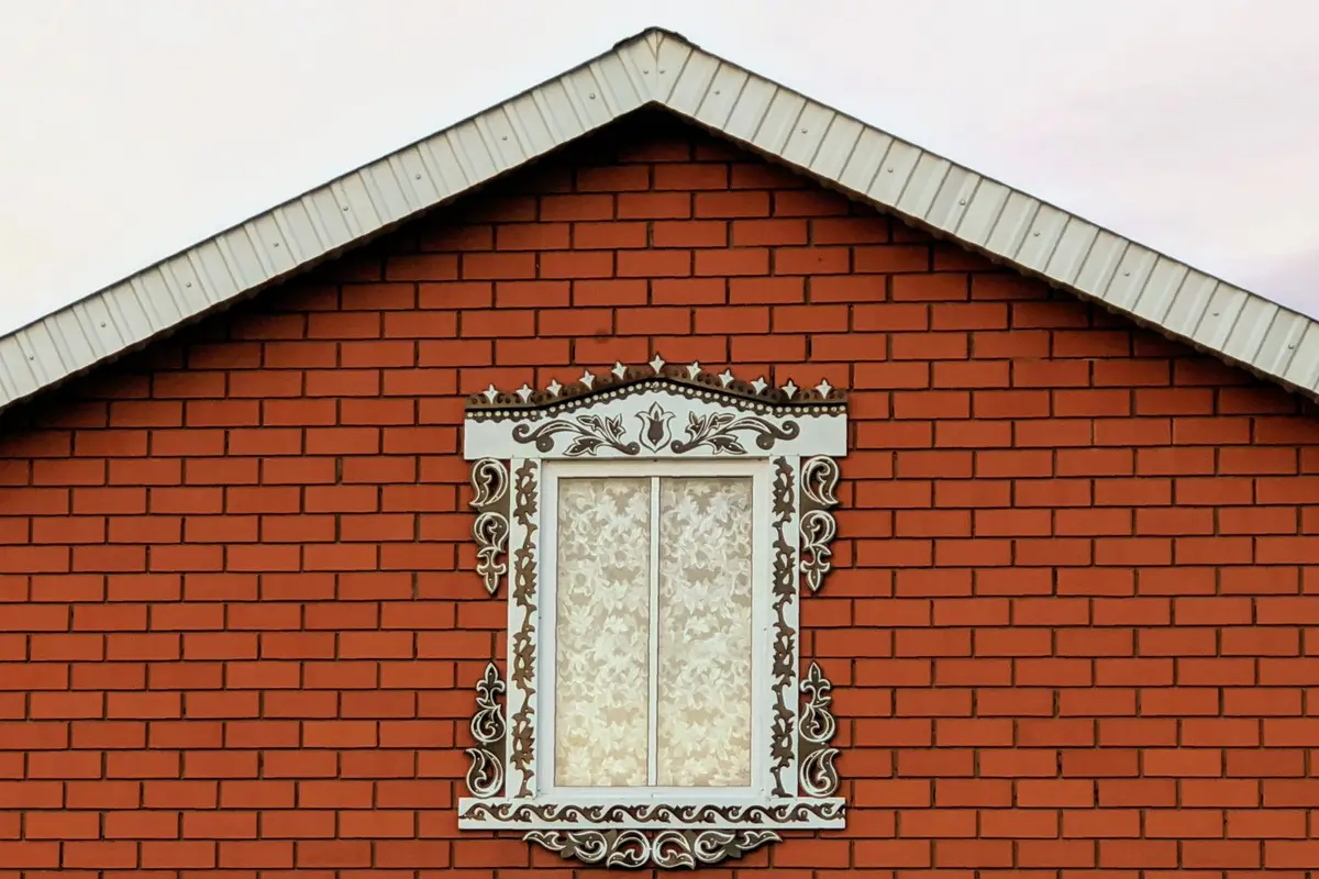 After: Side elevation — complete brick installation with proper wall tie placement