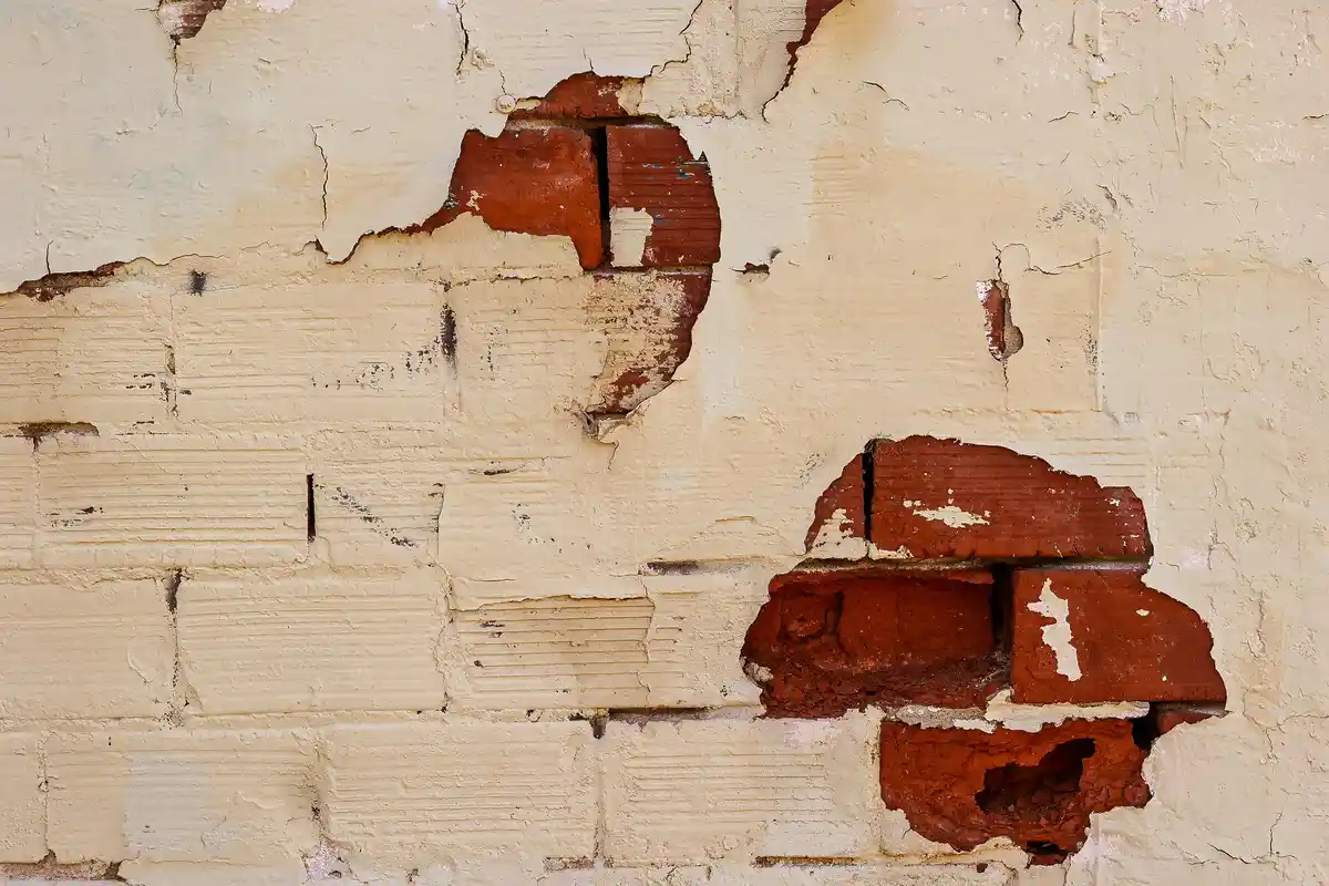 Before: Side elevation — complete brick installation with proper wall tie placement