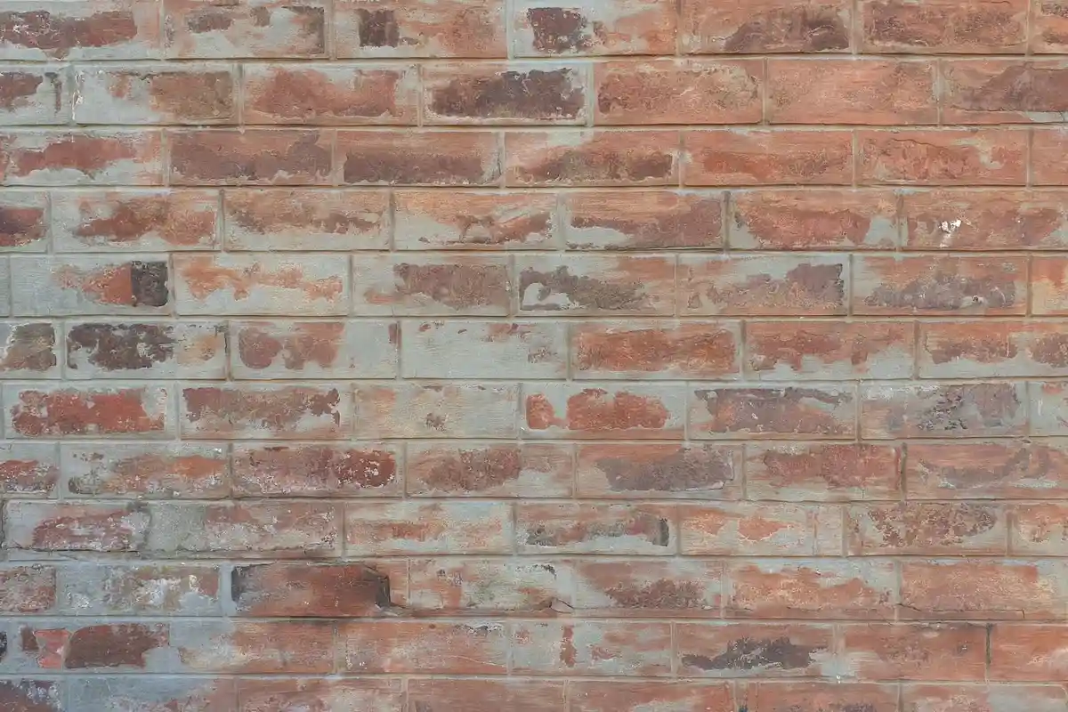 Before: Main facade — failed mortar joints removed and replaced with Type S color-matched mortar