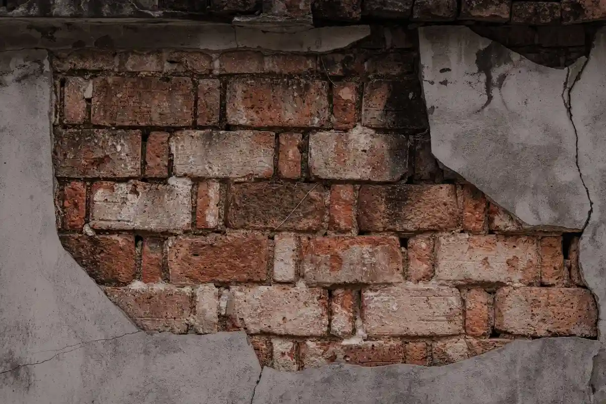 Before: Window surround — frost-damaged brick around opening replaced, lintel inspected and sealed