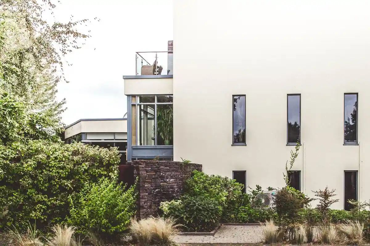 After: Side elevation — stone veneer cladding with soldier course cap detail at window sills