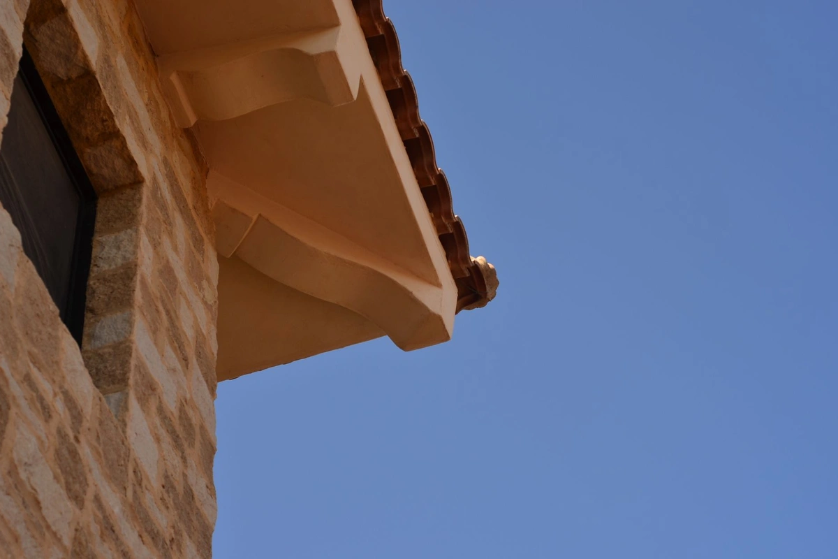 After: Entry surround — custom limestone arch and columns installed with precision alignment