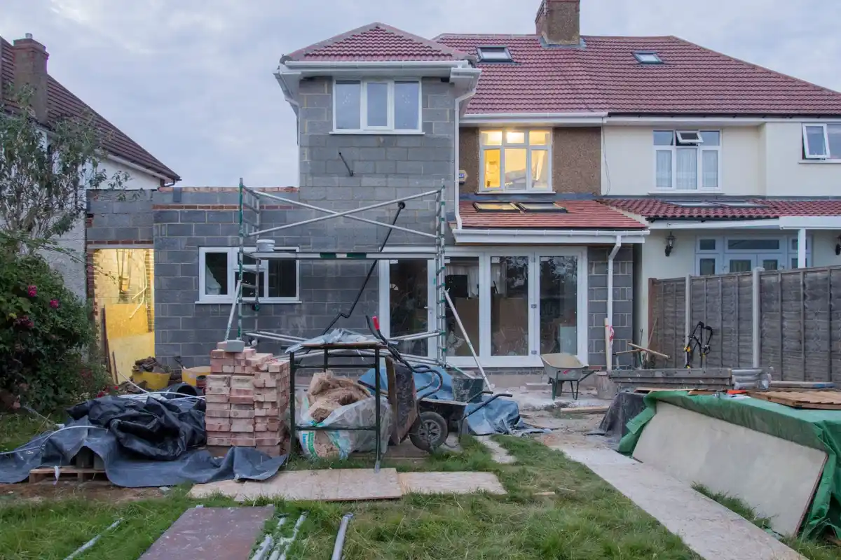 Before: Entry surround — custom limestone arch and columns installed with precision alignment