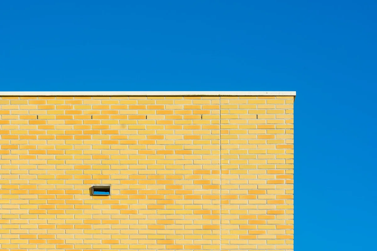 After: Main wall section — spalling brick removed and replaced with matched clay brick units