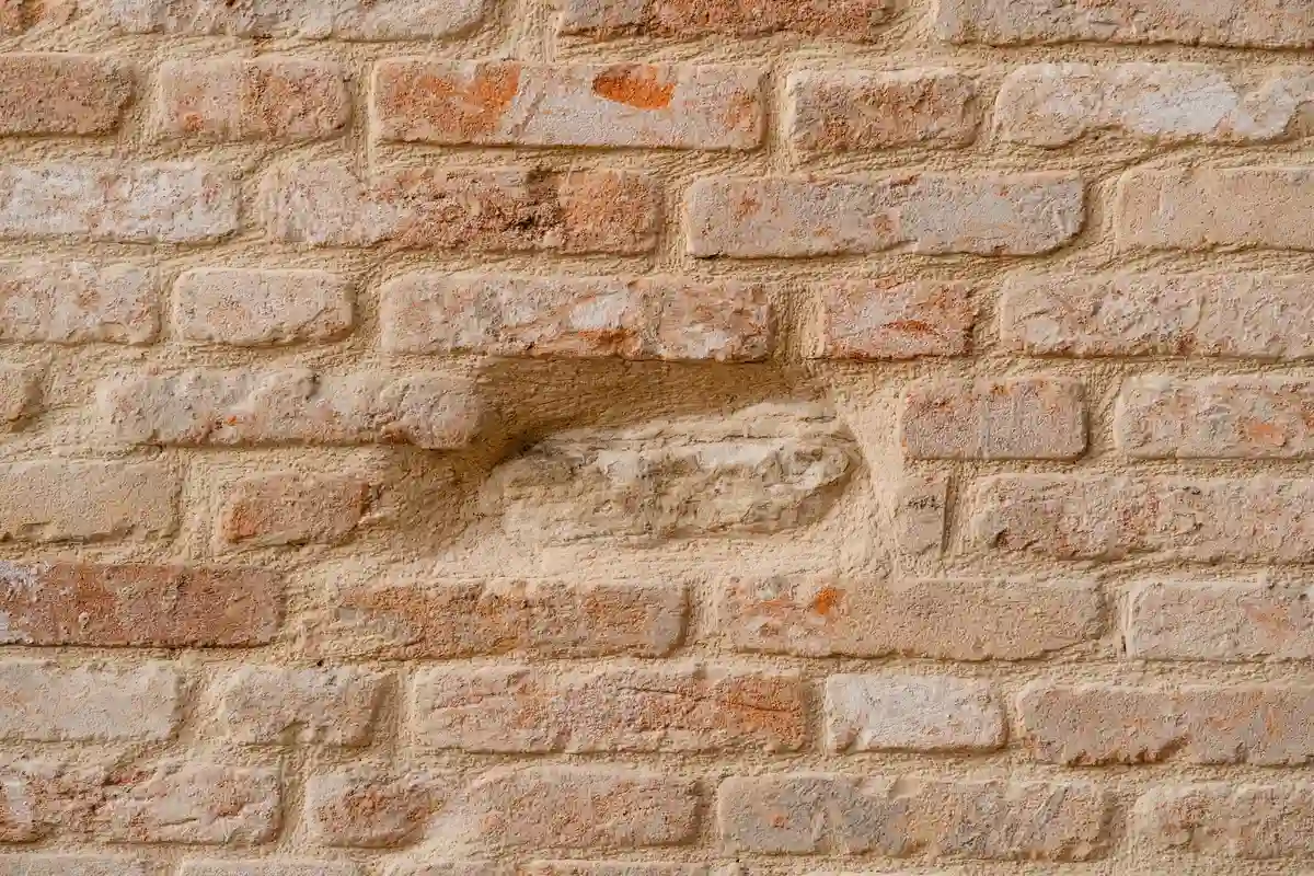 Before: Window surround — frost-damaged brick around opening replaced, lintel inspected and sealed