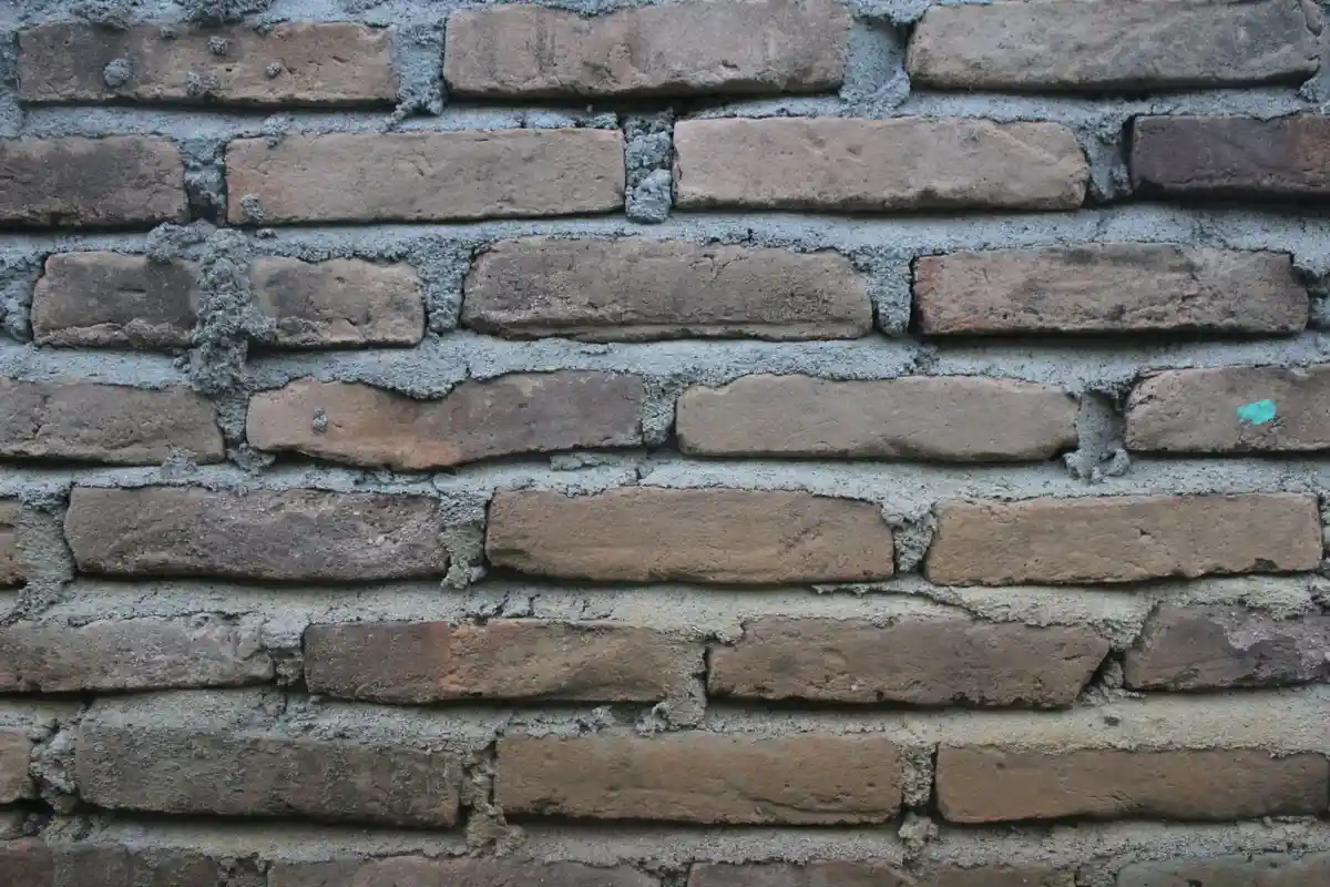 Before: Retaining wall — CMU block installed with vertical rebar and grout consolidation throughout