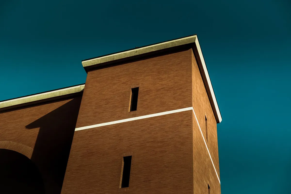 After: Main facade — original failing commercial brick restored and matched across full elevation
