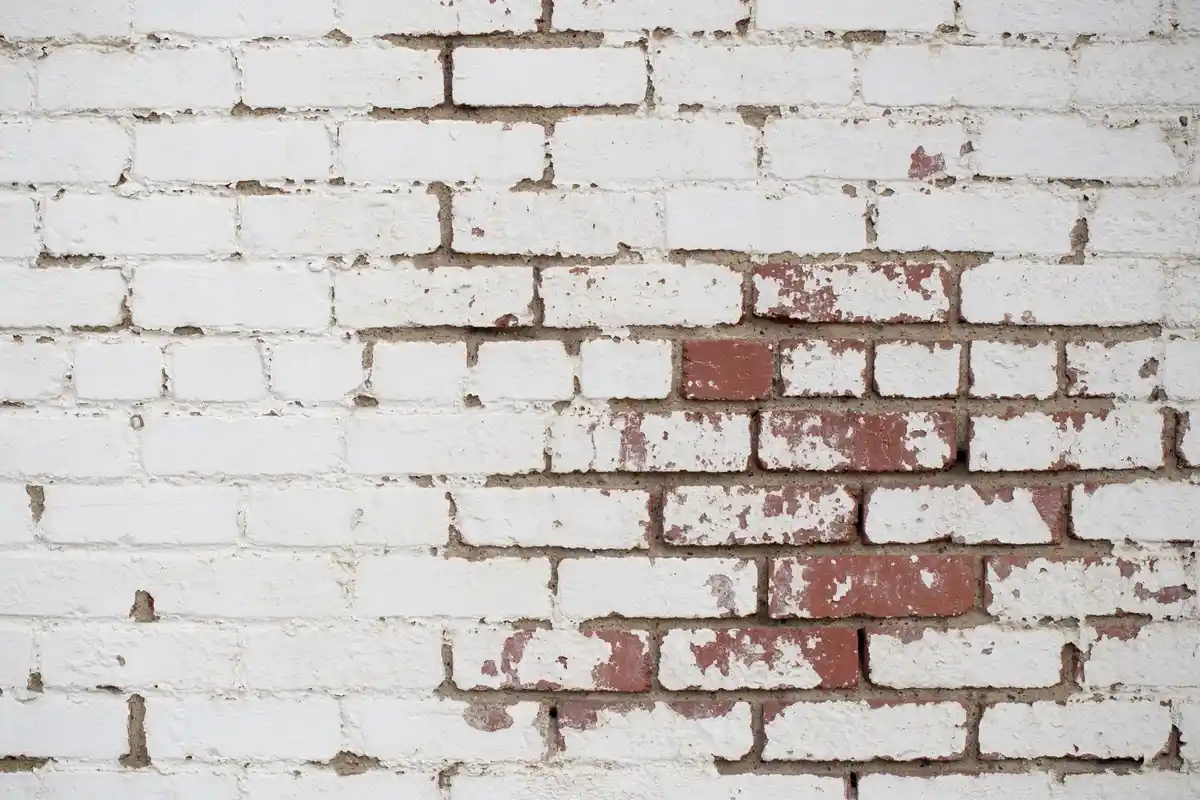 Before: Front facade — deteriorated brick replaced with color-matched full-bed clay brick